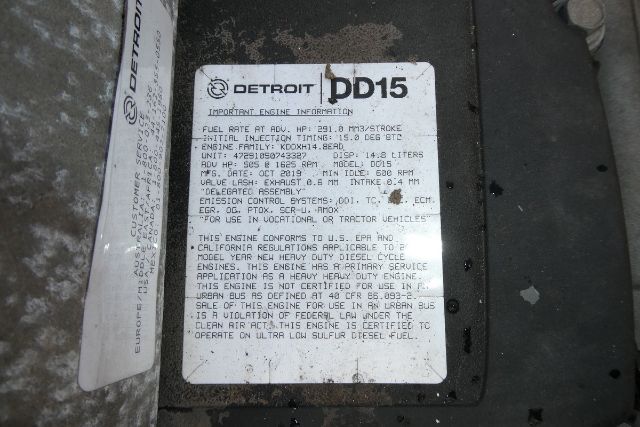 Detroit DD15 engine core label with model DD15 and engine information plate showing specs and regulatory text.