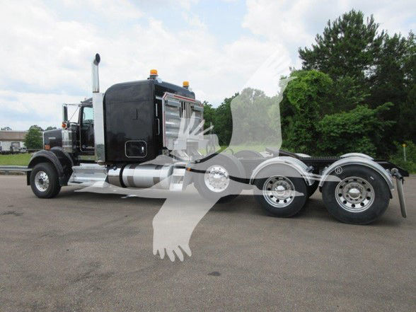 Kenworth W900B truck side view showing sleeper cab and triple rear axles