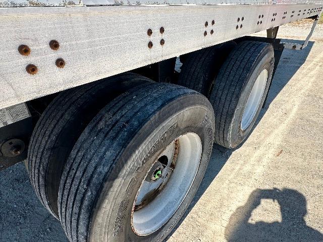 Dual rear wheels of a Wabash dry van trailer showing metal chassis and tires with rims.