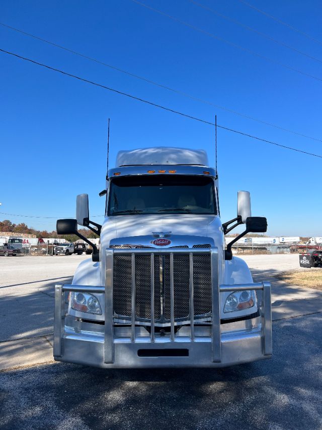 Peterbilt 579 front view showing grille and bumper with cattle guard and large mirrors.