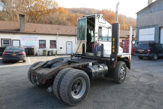 Truck tractor chassis with cab, large rear dual wheels, and vertical exhaust stack. Visible numbers '8148' on the cab support and the area around the fuel tank shows mechanical components.