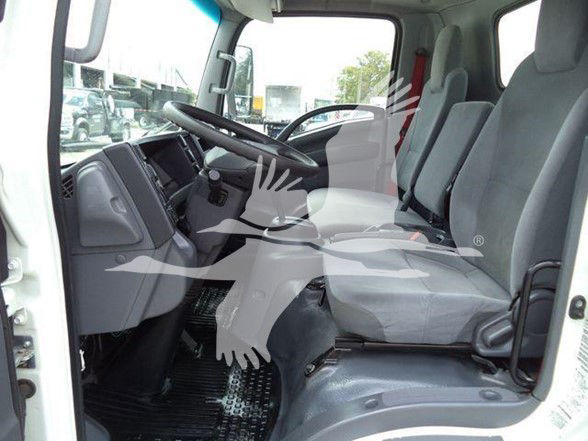 Truck cab interior with driver and passenger seats visible; steering wheel and dashboard; watermark overlay across seats.