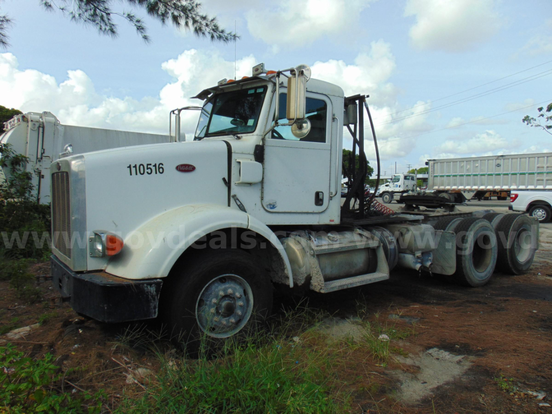 Peterbilt 365 cab and chassis with white paint, side view showing front grille, wheel, and dual rear axles.