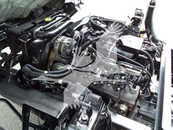 Chevrolet W4500 engine bay visible with components and hoses; no readable sticker text clearly legible