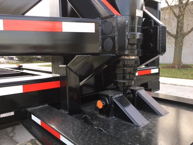 Trailer hitch and landing gear of a 2003 Wabash tipper trailer showing hydraulic components and mounting frame.