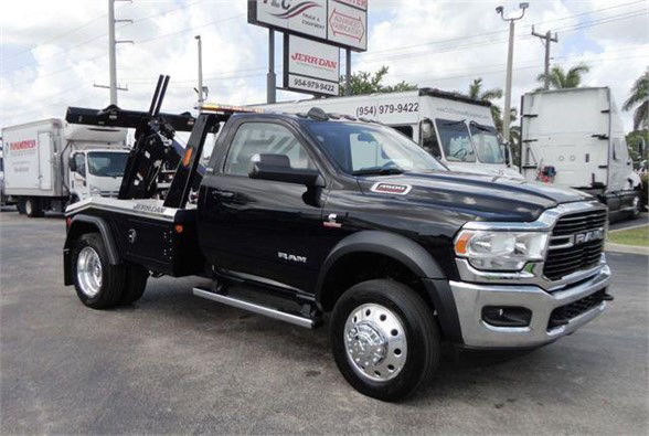 Ram 4500HD tow truck in black with chrome grille and dual rear wheel configuration.