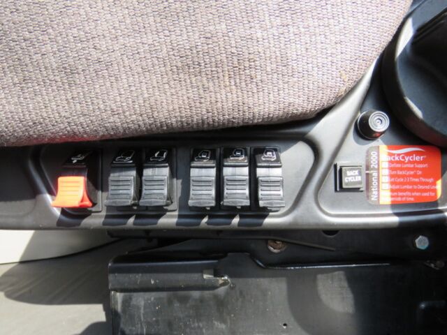 Truck dashboard switches panel with multiple rocker switches and orange safety latch visible, 2016 Freightliner Cascadia Evolution interior.