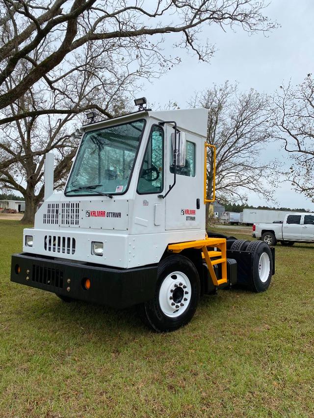 Kalmar Ottawa 4x2 yard truck with white cab and black bumper, yellow steps, large front grille and dual rear wheels.