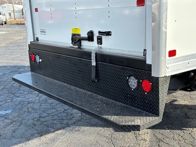 Ford F-550 box truck rear with diamond plate bumper and rear lights.