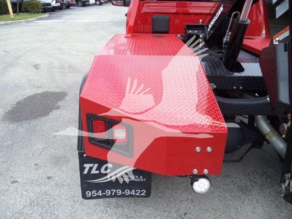 Red Ram 4500 truck rear with diamond plate toolbox, tow equipment, and TCL branding on mudflap showing contact number.