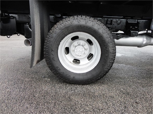 Wheel and tire of a 2012 Ram 3500 SLT dump truck showing steel wheel and treaded tire.