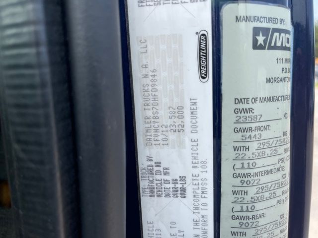 Label plate on Freightliner M2 with manufacturing, GVWR, GAWR and tire specs visible.