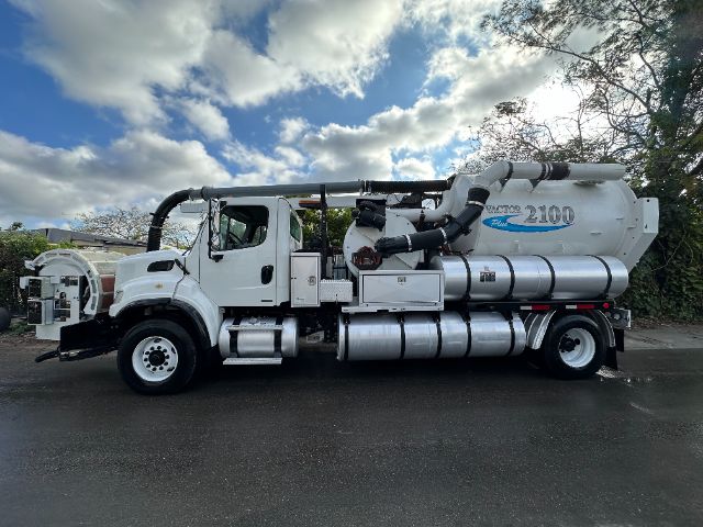 Forklift-style chassis Freightliner M2 vacuum truck with large cylindrical tank and hoses, side view.