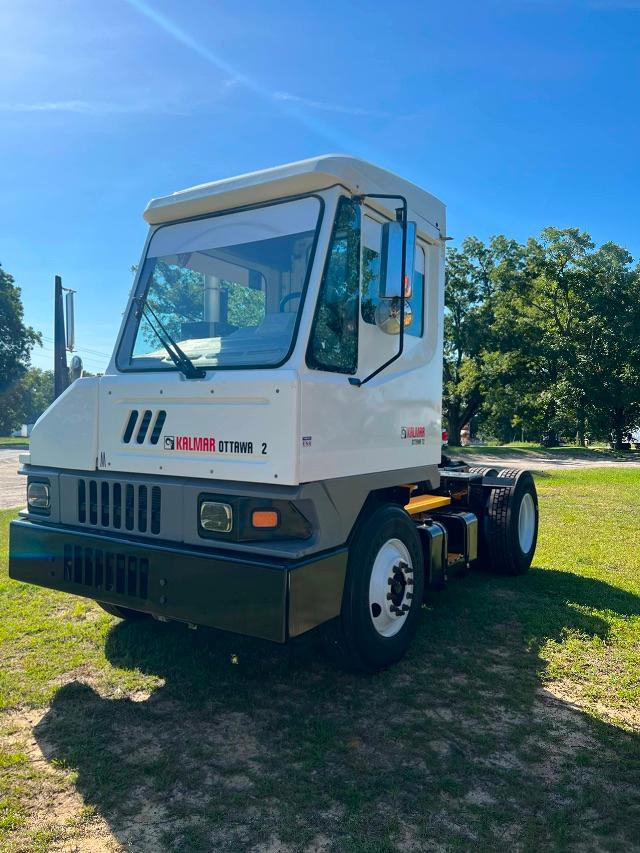 Kalmar Ottawa YT30 yard truck cab front view showing white body, black lower bumper, and side mirror.