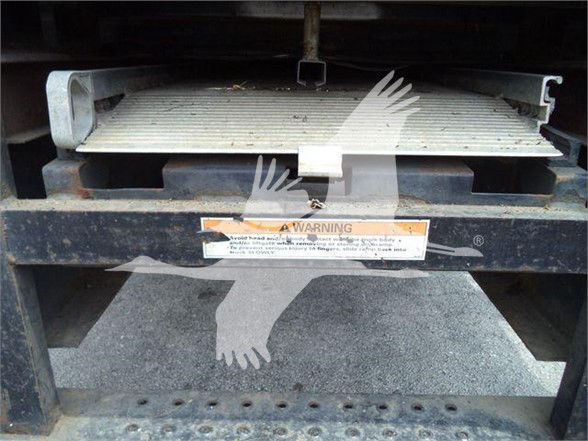Reefer truck front view showing cooling coil and warning label on black metal frame.