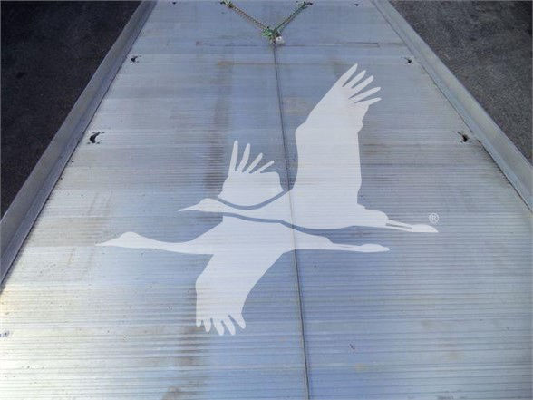 Flatbed or trailer roof with large white gull silhouette graphic.