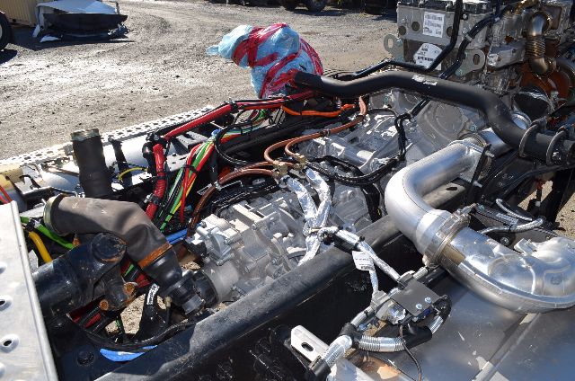 [Component] Engine bay showing fuel lines, aluminum intake manifold, wiring harnesses, and turbocharged engine in a Western Star 5700 XE cabover truck.