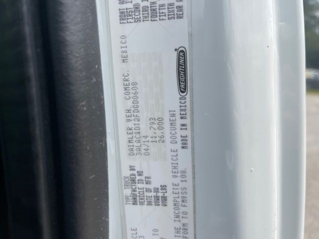 Label sticker on Freightliner M2 chassis with VIN/leaflet text and Freightliner branding, showing serial/weight and manufacturing details.