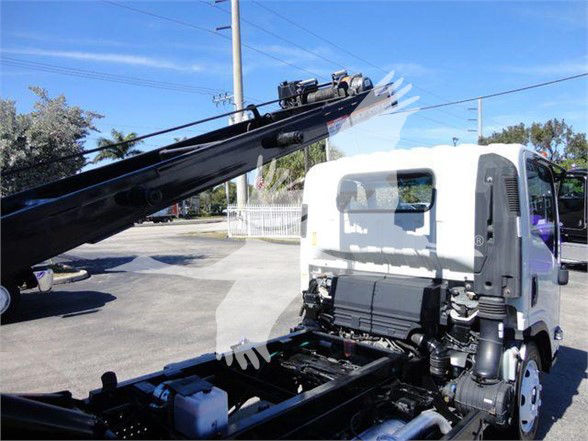 Isuzu NRR truck cab and crane equipment visible in a used truck listing. No specific labels readable on the body from this angle.