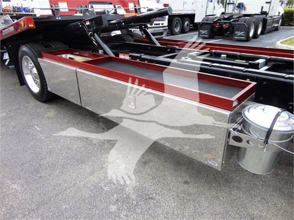 Peterbilt 337 truck chassis showing aluminum storage boxes and adjacent fuel tank.