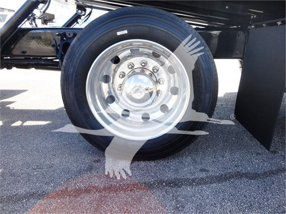 Wheel and tire on a Peterbilt 337 truck with polished chrome hubcap and black tire; no visible text.