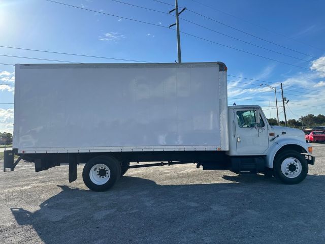 Box truck side view showing cargo box and cab of a 1997 International 4700 with VIN 1HTSCAAM4VH463682.