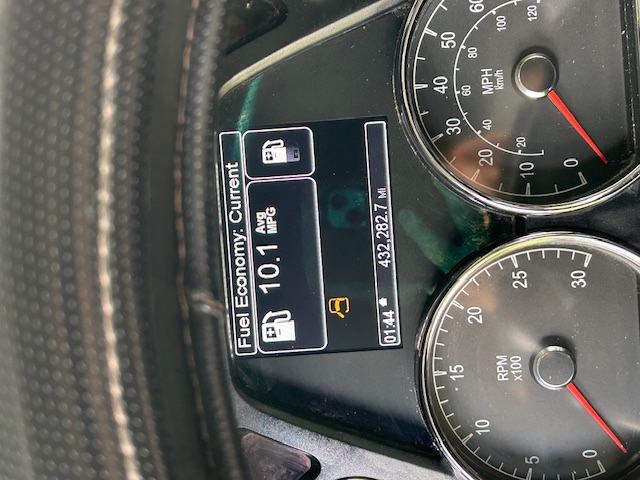 Dashboard showing Fuel Economy: Current 10.1 Avg MPG with digital display and analog tachometer and speedometer; odometer reads 432,282.7 miles.