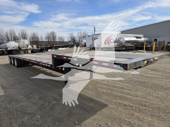 Tri-axle steel drop deck trailer with flat expandable deck, black frame, multiple axles, rear ramp, and storage area. VIN and stock number not visible on signs in image.