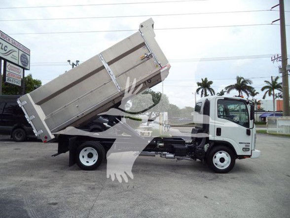Isuzu NPR HD dump truck with bed raised, side view showing cab and hydraulic dumping mechanism.