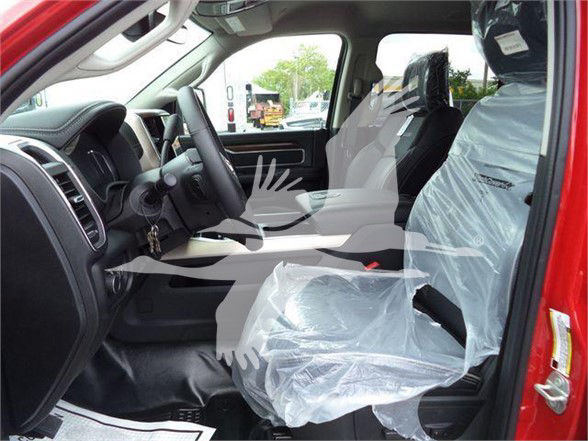Ram 5500 interior showing front seats, steering wheel, dashboard; plastic protective seat covers on both front seats.