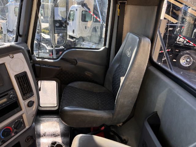 Cab interior of 2013 Mack CHU613 Pinnacle with driver seat and dashboard visible.