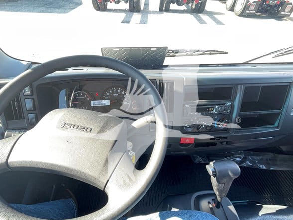 Isuzu NPR HD cab interior showing steering wheel, dashboard, and center console.