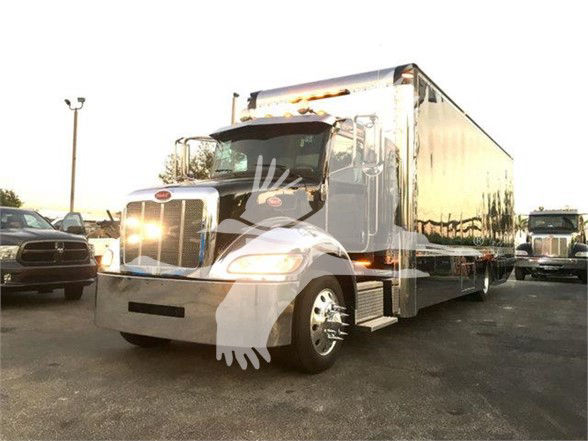 Peterbilt 337 tow truck in a stock image showing a chrome front, large boxbed, and standard cab with curved windshield.