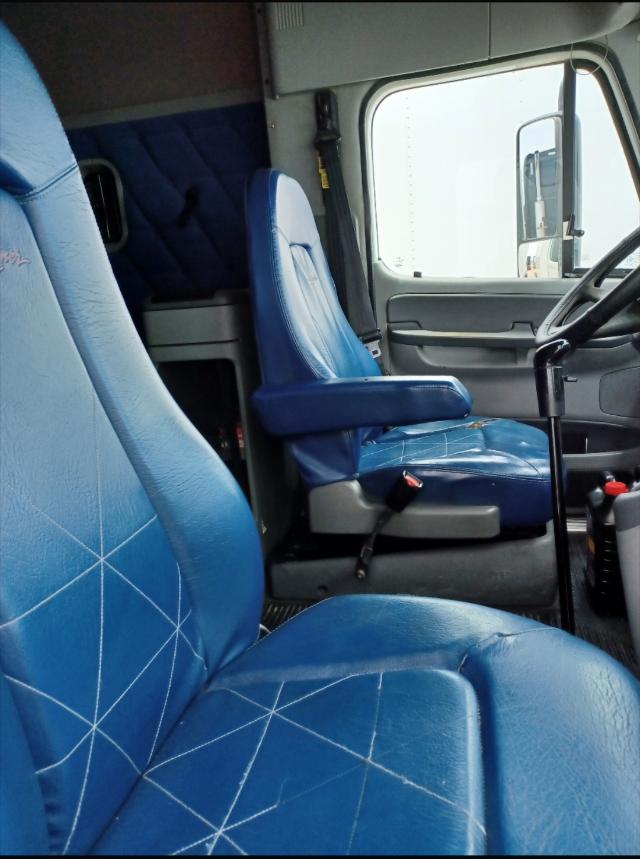 Interior of a 2007 Freightliner Columbia truck cab with blue seats and steering wheel visible.
