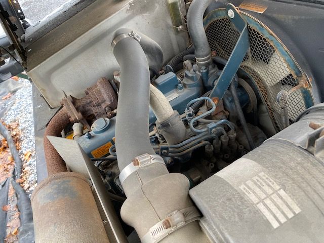 Kesmac F5000 lift engine bay showing hoses, radiator fan, and air intake tubes.