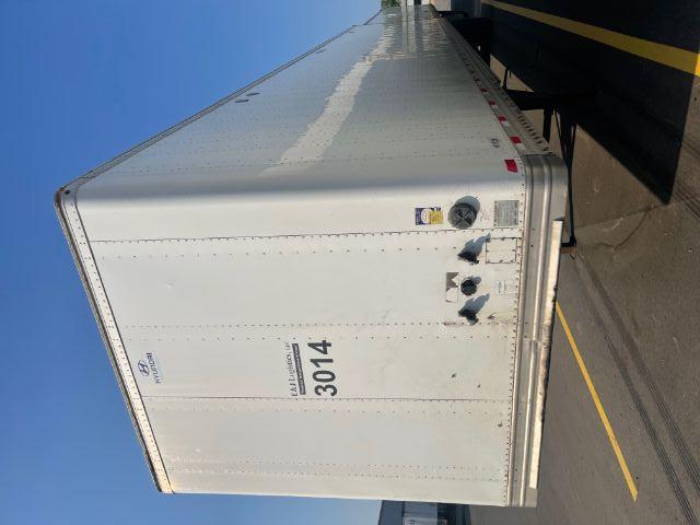 Rear view of a white Hyundai trailer with a large '3014' number plate and small logos, van/trailer style, on a paved lot.