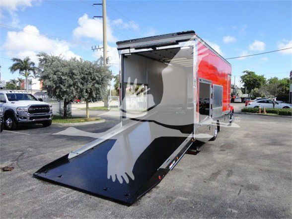 MD6 Tow truck with open rear cargo area and ramp extended, red exterior with black ramp, showing interior cargo space.