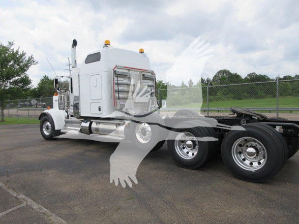 Kenworth W900L truck with sleeper, side view showing rear wheels and chassis.