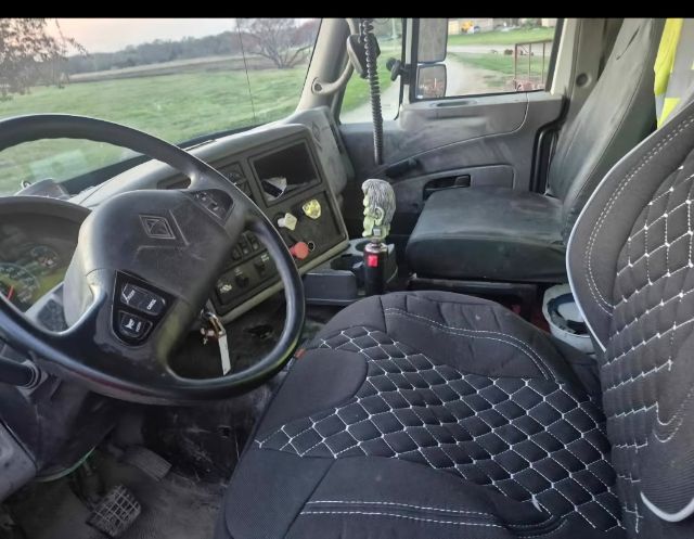 Interior view of a 2008 International 8600 cab showing steering wheel, dashboard, and seats with diamond-stitched seat covers.