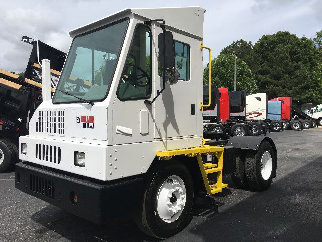 Kalmar Ottawa YT30 yard truck cab and chassis with white body and yellow steps, front grille and logo visible.