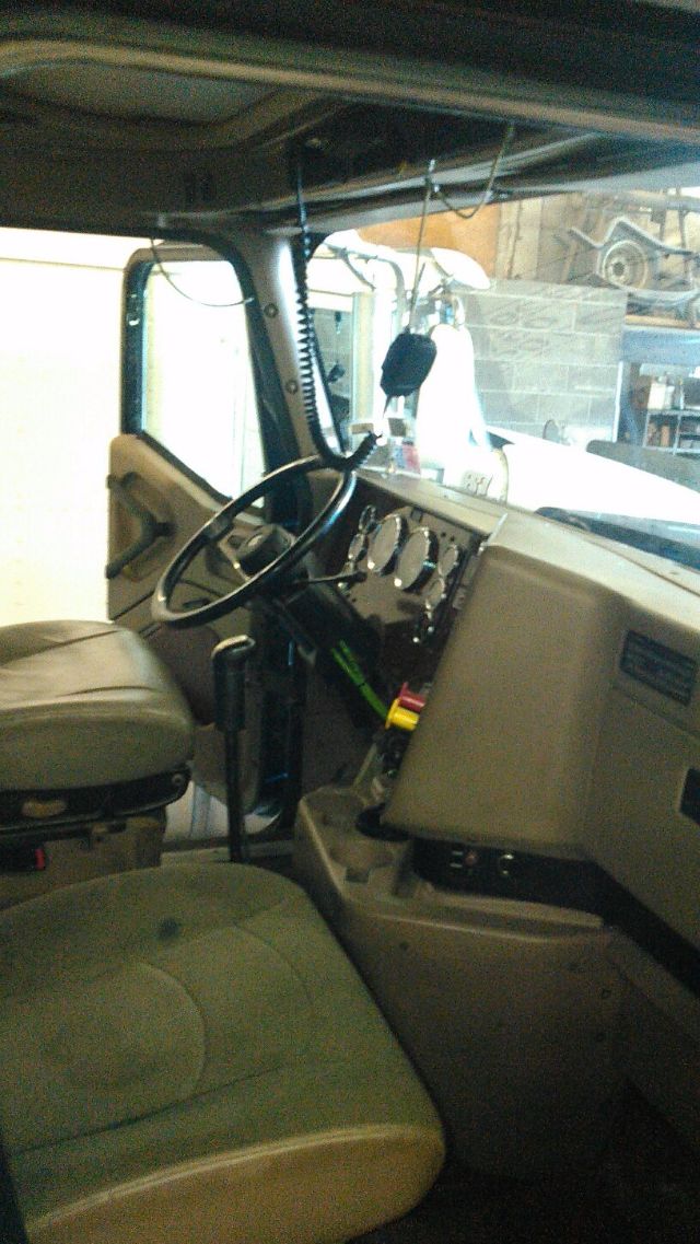 Interior of a 2007 International 9900i truck cab showing steering wheel, dashboard gauges, and driver's seat.