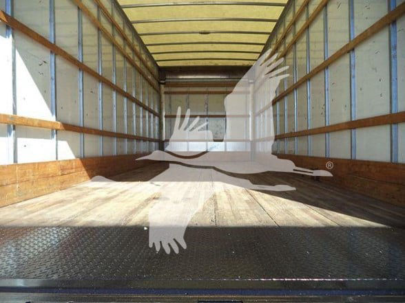Large empty truck trailer interior with wooden sidewalls and metal floor, stock photo watermark overlay.