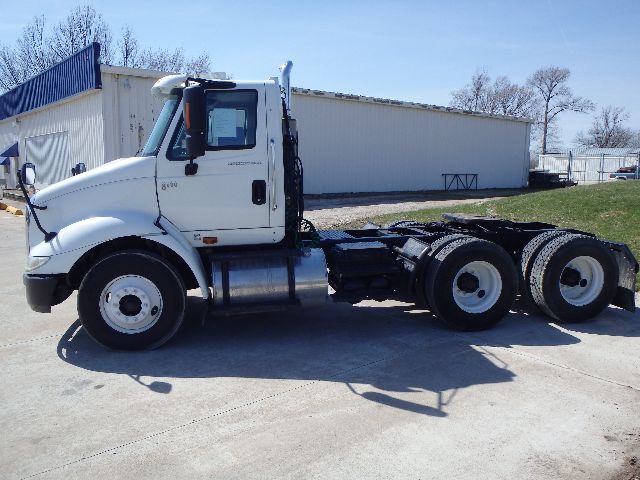 White International 8600 conventional daycab tractor, side view, showing front cab, fuel tanks, and dual rear axles with fifth wheel mount.