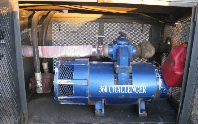 60- degree view of vacuum tanker trailer engine bay with a blue 360 Challenger pump and red reservoir fittings visible.