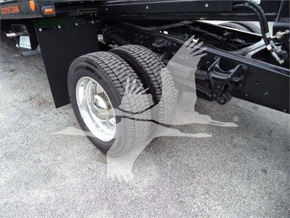 Truck rear dual wheels with heavy-duty suspension and frame, part of a new International CV chassis, showing tires and undercarriage components.