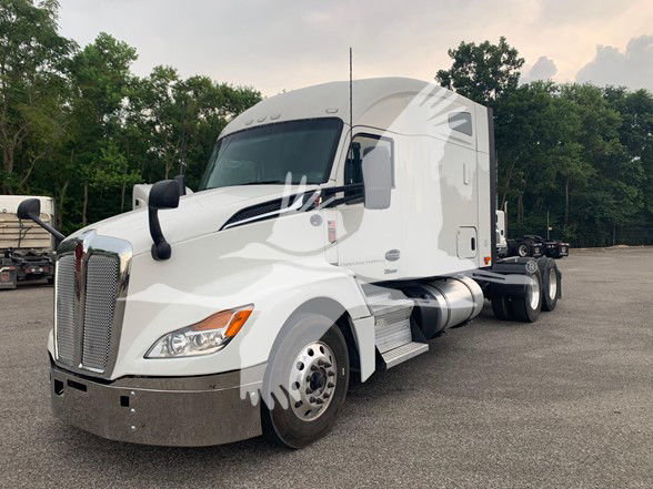 Kenworth T680 2024 conventional sleeper truck in white, front quarter view with sleeper cab, chrome grille, and dual rear axles.