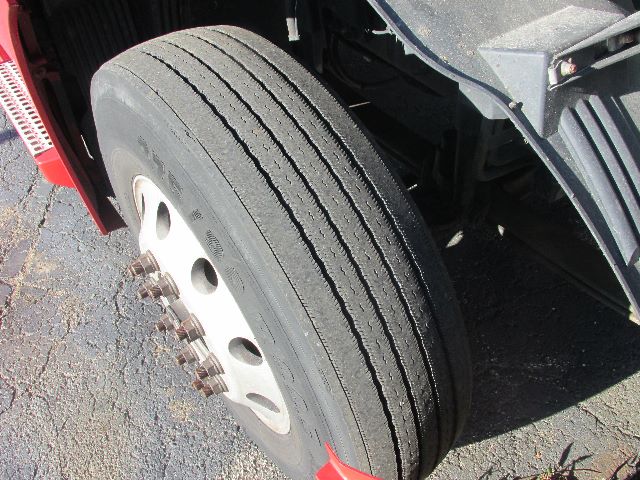 Front wheel of a Volvo 780 sleeper truck showing dual rear dual tires and wheel hub with lugs