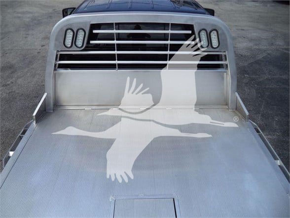Ram 5500 Silverado-style front grille and aluminum flatbed with honeycomb light pattern, truck cab in background.