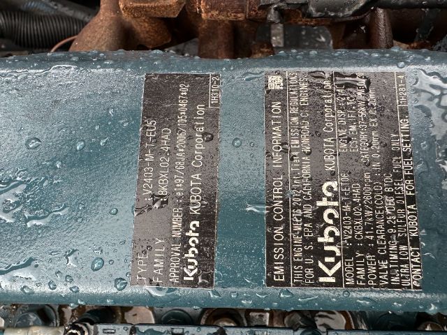Emissions control information plate on Isuzu NPR-HD engine showing model, family, and engine specifics in vertical orientation.