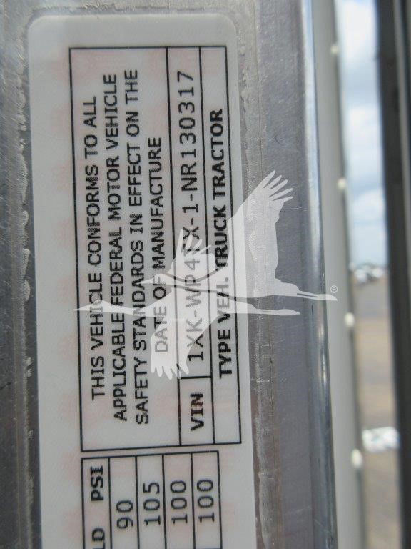 Label on Kenworth W900L truck door with VIN, stock number, and safety note. Text includes: This vehicle conforms to all applicable federal motor vehicle... VIN 1XKW... Type: Truck Tractor.